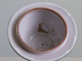 a white bowl with a brown rim sitting on a table
