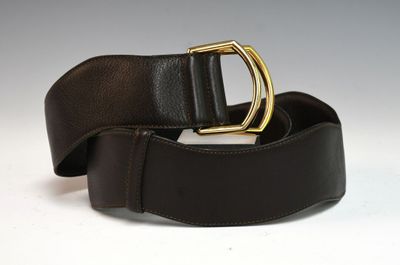 a close up of a brown belt with a gold buckle