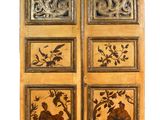 an image of a pair of wooden doors with carvings on them