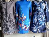 three dresses on display on a shelf in a room