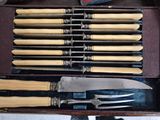 many knives and knives in a case on a table