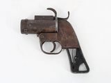 an old gun on a white surface with a white background