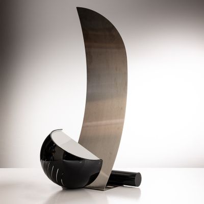 a black and silver sculpture on a white surface