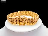 an image of a gold bracelet on a mannequin