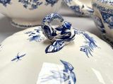 a blue and white dish with a bird on it