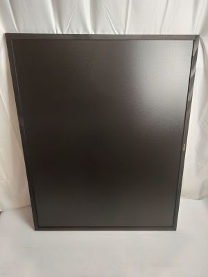 the black box is sitting on a white surface next to a white sheet