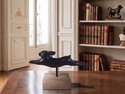 a statue of a dog on a table in a room