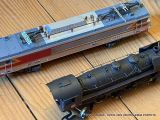 two model trains sitting on a wooden table