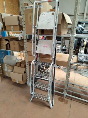 a metal rack with boxes on it in a warehouse