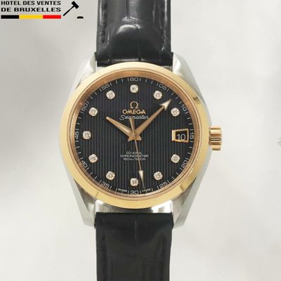 a close up of a watch on a black leather strap
