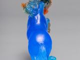 a blue glass vase with a blue horse on it