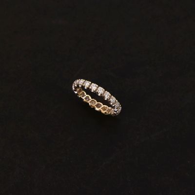 a white gold ring with diamonds on a black background