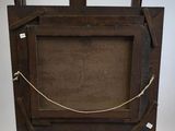 an old wooden easel with a rope around the top of it