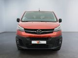 the front view of a red van parked in a white room