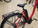 a red bike that is parked next to a bunch of other bikes