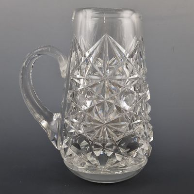 a glass pitcher that is sitting on a table