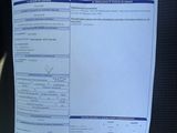 a picture of a car ' s driver ' s license on the dashboard