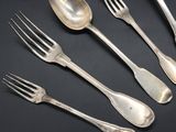 six forks and spoons on a table with a black background