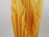 a vase that has a bunch of yellow pieces of paper in it