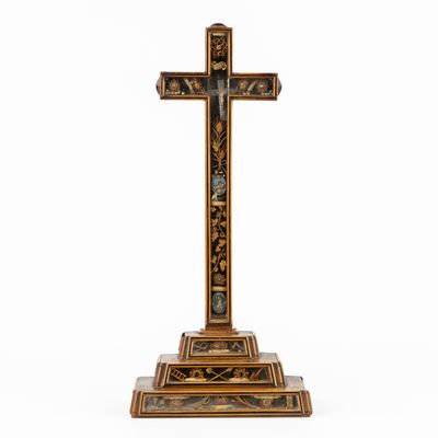 a wooden cross on a stand with a white background