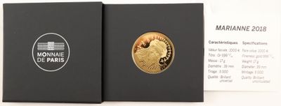 the coin is in a black box on the table next to a business card