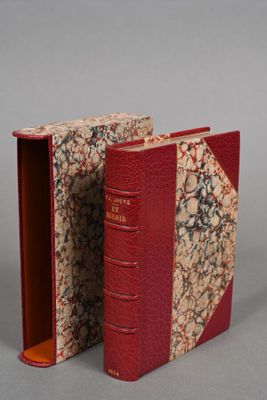 a red book that is open on a gray surface
