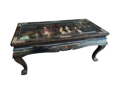 a black table with a glass top and a black base