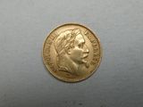 a close up of a gold coin on a white surface