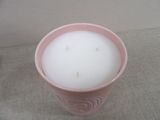 a candle that is sitting in a cup on a table