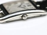 a close up of a watch on a white surface