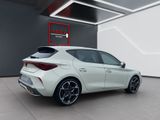 the rear end of a white car parked in a garage