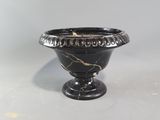 an image of a black vase sitting on top of a white table