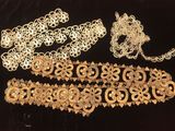 a group of gold jewelry on a black surface