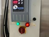 a control panel with a clock on it in a room