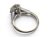 a close up of a diamond ring on a white surface