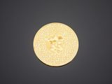 a close up of a gold coin on a black background