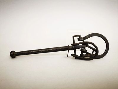 a small metal object that is on a white surface