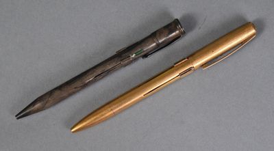 two pens sitting next to each other on top of a table