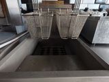 a fryer that has two baskets on the side of it