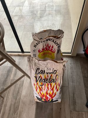 a bag of food sitting on the floor next to a chair