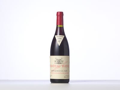 a bottle of red wine sitting on top of a table