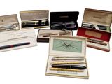 a lot of pens and other items in a box