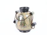 a small vase with a handle and a rope around it