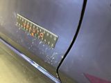 a sticker that says stop on the side of a car