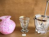 three glass vases sitting next to each other on a table