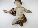 a small statue of a child hanging on a wall