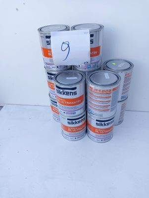 several cans of paint are stacked on top of each other