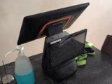 a laptop computer sitting on top of a desk next to a bottle of water