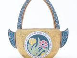 yellow and blue hand painted basket with flowers on it