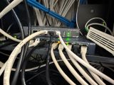 a bunch of cables connected to a switch on the wall